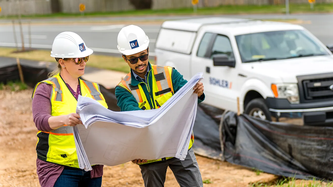 Bohler engineers in the field reviewing site plans