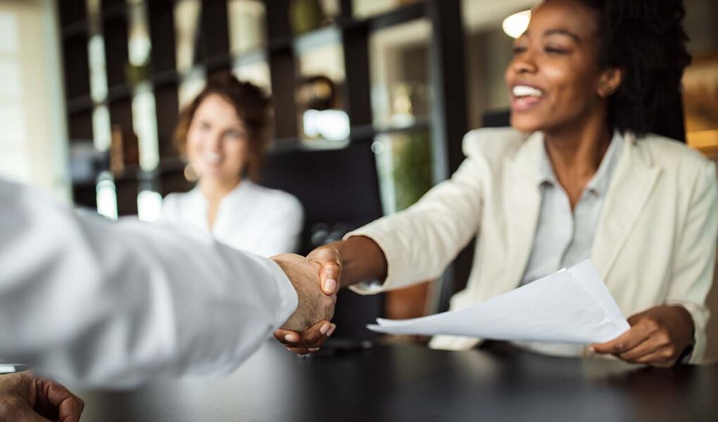 Business woman making plans with somebody, shaking hands.