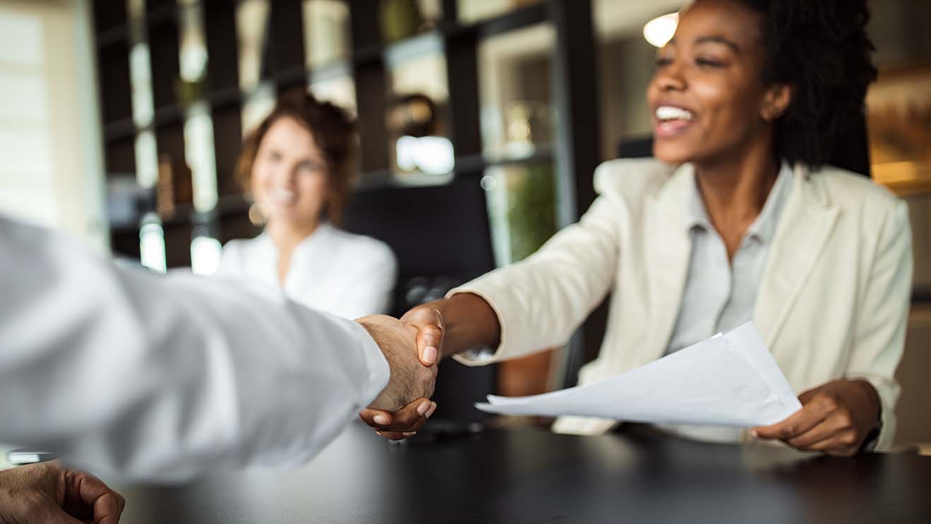 Business woman making plans with somebody, shaking hands.