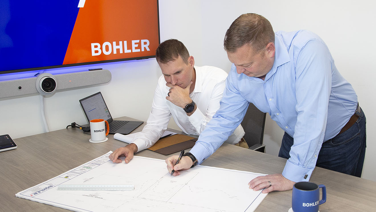 Chas Evans and Nate Kirshner looking over a set of plans in Bohler's Fairfield, CT office.