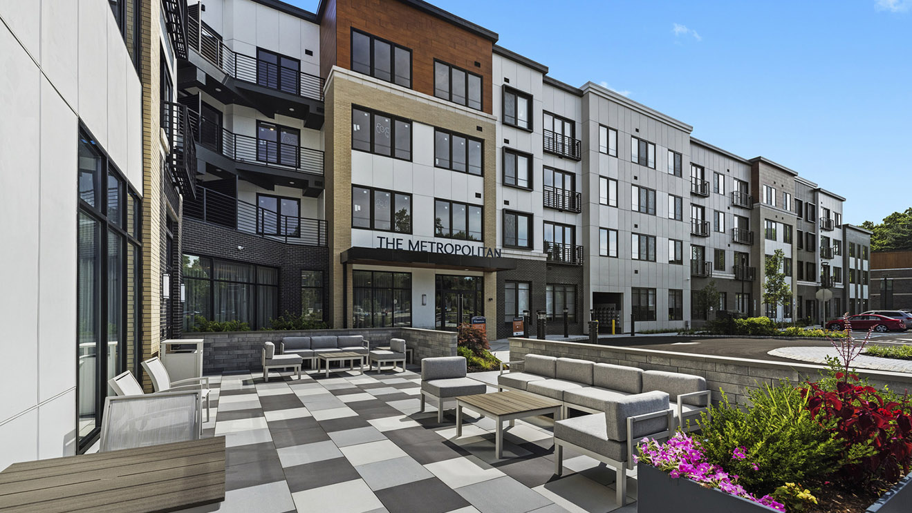 Multifamily building entrance, seating, plantings, hardscaping