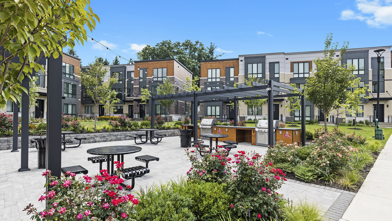 Beautiful outdoor amenity space, outdoor kitchen, grilling station, flowers and plantings, outdoor patio