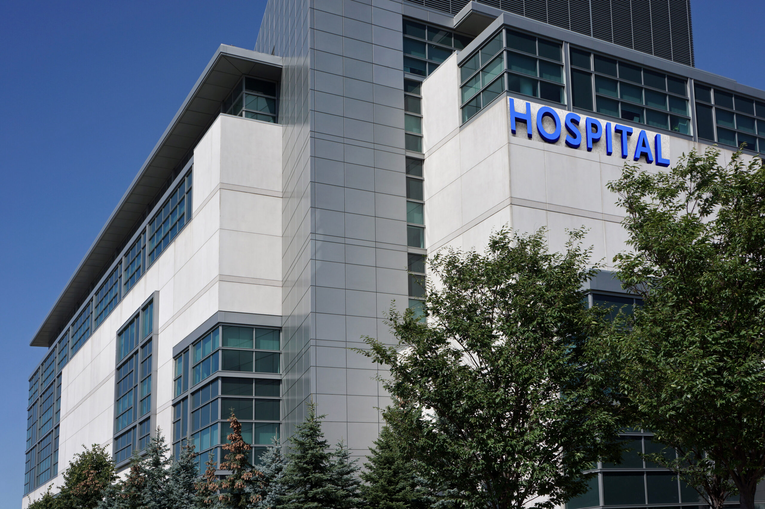 modern hospital building in a suburban setting surrounded by trees